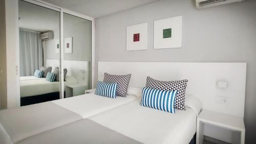 圣地亚哥港罗格斯凯萨蓝海酒店的白色的客房配有床和镜子