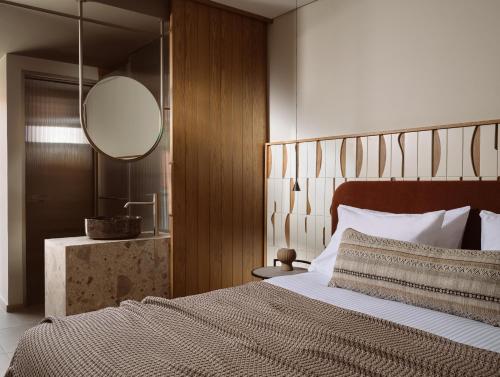 卡拉马孔Marelen Hotel Zakynthos的一间卧室配有一张大床和镜子