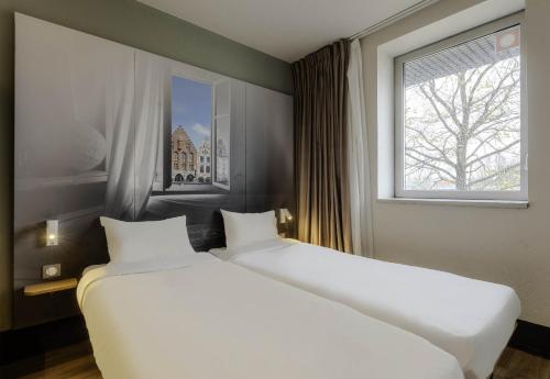 阿拉斯B&B HOTEL Arras的带窗户的客房内的2张白色床