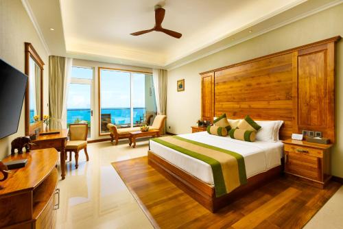 乌纳瓦图纳Araliya Beach Resort & Spa Unawatuna- Where you meet the sea all year的一间卧室配有一张床、一张书桌和一台电视