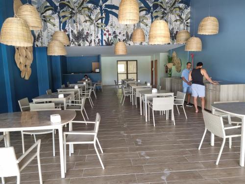Rio FormosoEcoresort - Praia dos Carneiros的两人站在带桌椅的餐厅