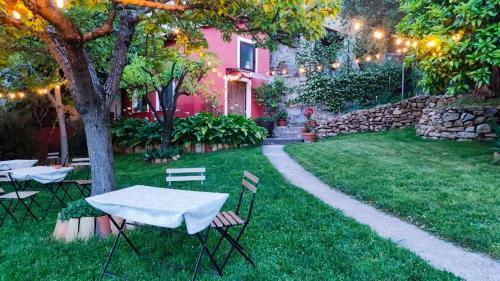 维贾内洛Tana Libera Tutti 1 Nature, Yourself, Love的一个带石墙的庭院里的桌椅