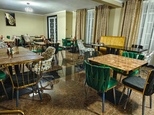 利隆圭Annavilla7 Lilongwe Aparthotel的餐厅设有木桌、椅子和窗户。