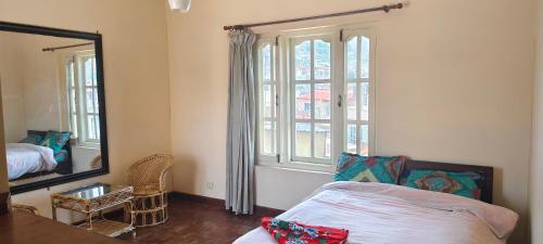 加德满都Bodhi Homestay的一间卧室配有一张床、镜子和窗户