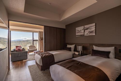 留寿都村The Vale Rusutsu的酒店客房设有两张床和一个阳台。