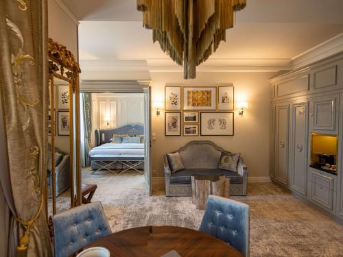 克拉科夫Bachleda Luxury Hotel Krakow MGallery Hotel Collection的一间带桌子的客厅和一间卧室