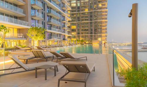 迪拜YOUR STAY APARTMENTS的一座带躺椅的游泳池和一座建筑