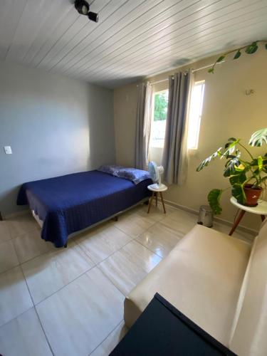 纳塔尔Nosso lar em Natal - quarto的一间卧室配有蓝色的床和沙发