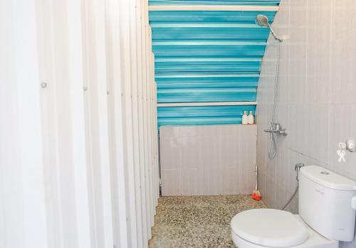 PadanganRainbow Glamping的浴室设有卫生间和蓝色条纹淋浴帘