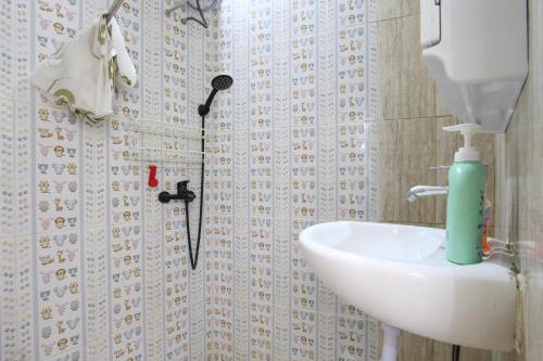 沙拉迪加Capital O 93939 Oikodomeo的一间带水槽和烘干机的浴室