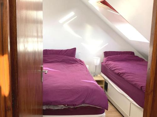 牛津A Comfortable Room in a Friendly Home in Headington, Oxford的一张带紫色床单的床