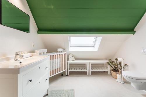 布鲁日Fall Eighteen by Romy&Travis的一间带婴儿床和绿色天花板的浴室