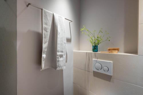 布鲁登茨Val Blu Sport | Hotel | SPA的白色的浴室,墙上挂着毛巾