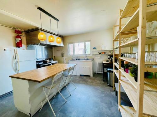 泰道沙克La Merveilleuse - Baie de Tadoussac Vue panoramique的厨房配有木制柜台和冰箱。