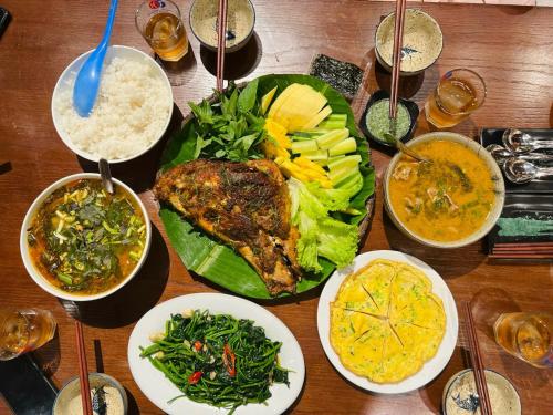 峰牙Phong Nha Eco Village的木桌,放有食物和碗
