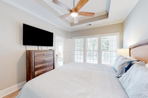 默特尔比奇Inlet Dream的一间卧室配有一张床和一台平面电视
