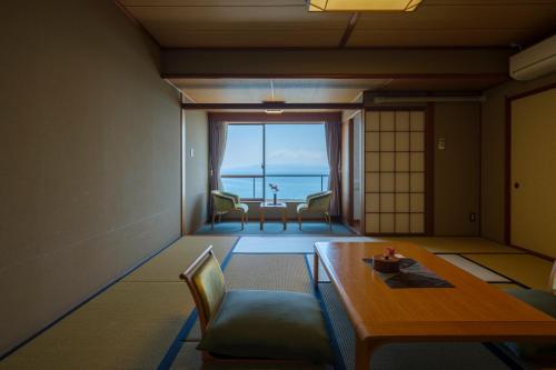 指宿市Fufurotenburonoyado Ginsyou的配有桌椅的海景客房