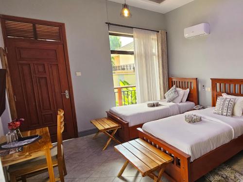 NgateuMedan Hotel的客房设有两张床和窗户。