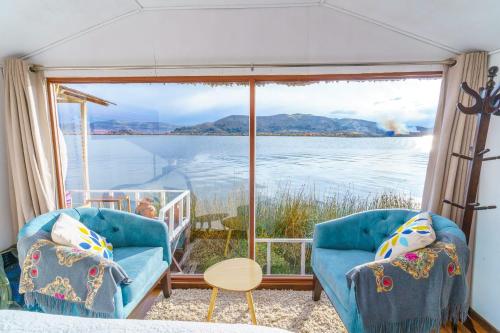 UrosTiticaca Uros Summa Paqari的一间设有两把椅子并享有水景的客房