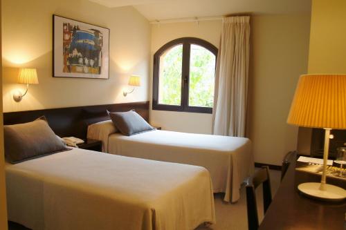 阿尔武希耶斯托雷斯酒店的酒店客房设有两张床和窗户。