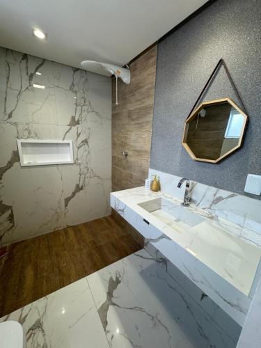 纳塔尔Casa de alto padrão的一间带水槽和镜子的浴室