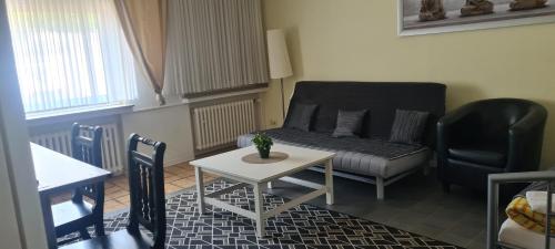 韦塞尔祖尔奥酒店的客厅配有沙发和桌子