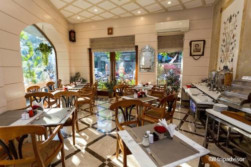 孟买福特住宅酒店的餐厅设有桌椅和窗户。