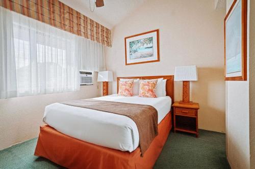 利胡埃Banyan Harbor Resort的一间设有大床和窗户的酒店客房