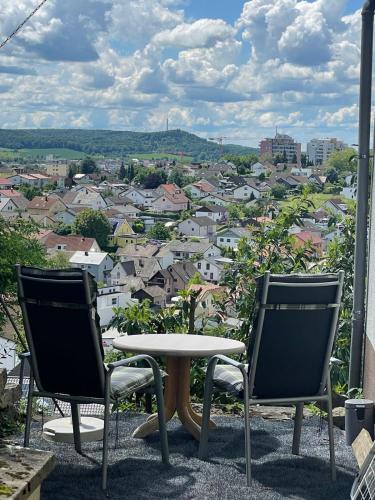 辛斯海姆Ferienwohnung Panoramablick的市景阳台配有两把椅子和一张桌子