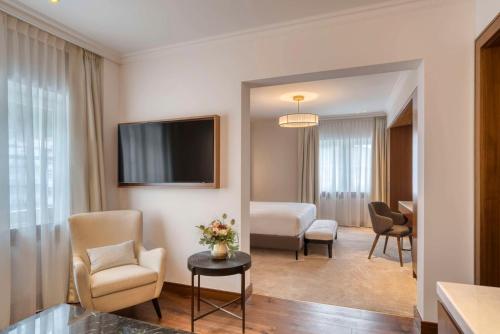 圣莫里茨Grand Hotel des Bains Kempinski的酒店客房,配有床和电视