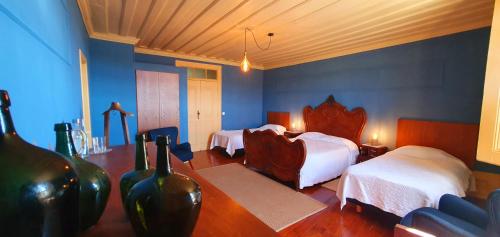 塞亚Casa do Fundo - Sustainable & Ecotourism的酒店客房,设有两张床和蓝色的墙壁