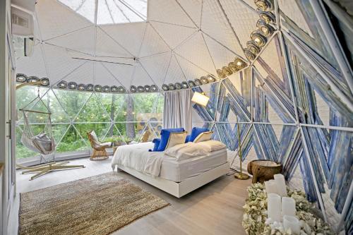 利斯堡Dream Dome Getaway near Leesburg的一间卧室设有一张床和一个大型玻璃墙