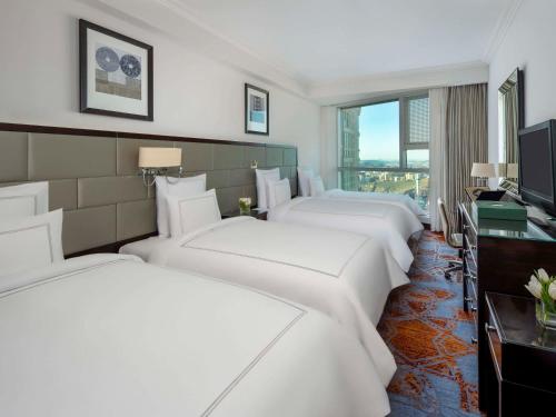 麦加麦加瑞士酒店的酒店客房设有四张床和电视。