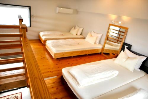 本部Hotel Little Swiss House的带两张双层床的客房中的两张床