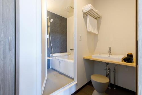 坂井市Oruga Resort -Trailer Cottage & Cafe -的带浴缸、盥洗盆和卫生间的浴室