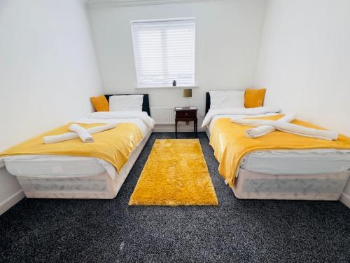 Great BursteadTranquil Haven: 3-BR House的配有黄色床单的客房内的两张床