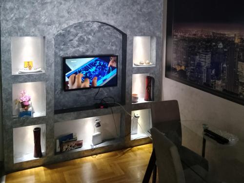 乌日策Apartmani Kristina & Kriss的一间带电视和玻璃桌的客厅