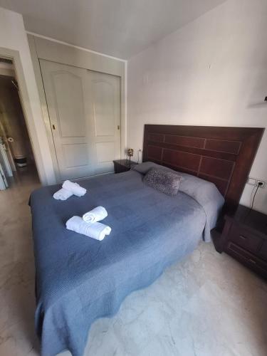 贝纳尔马德纳Apartamentos Jowi - Piso amplio y Familiar的一间卧室配有一张大床和毛巾