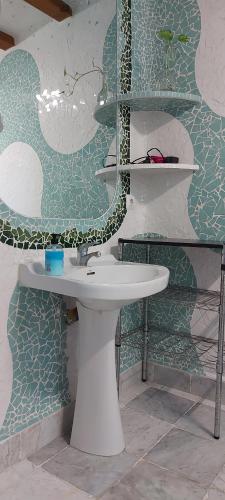 洛斯卡尼奥斯德梅卡Mi Cachito的浴室设有白色水槽和绿色白色的墙壁。