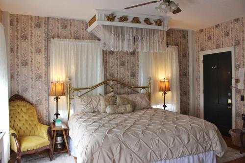 GreenfieldThe Greenfield Inn的一间卧室配有一张带花卉壁纸的大床