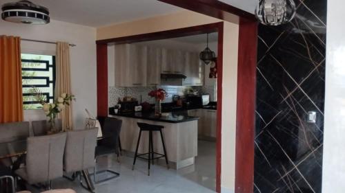 圣多明各Villas tropicales的厨房以及带桌椅的起居室。