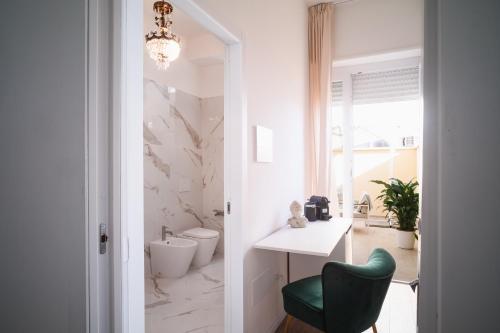 奥里斯塔诺New Elegance Suites Guesthouse的一间带绿色椅子和水槽的浴室