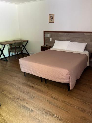 康沃尔哈德逊卡德特汽车旅馆的一间卧室配有一张大床和一张桌子