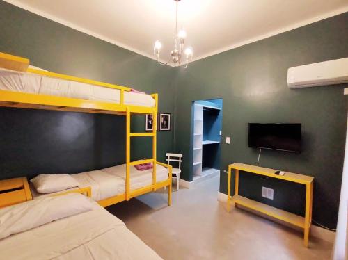 门多萨Hotel Windsor Mendoza的一间卧室配有两张双层床和一台平面电视