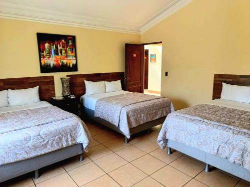 危地马拉Hotel Don Felipe Aeropuerto的一间酒店客房,房间内设有两张床