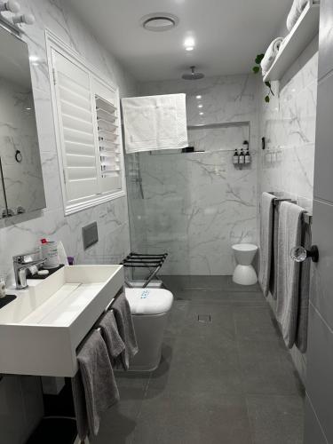 OrmeauLuxury Boutique Self-Contained Private Granny Flat的白色的浴室设有卫生间和水槽。