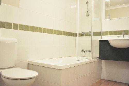 洛甘利布里斯班美特酒店的白色的浴室设有卫生间和水槽。