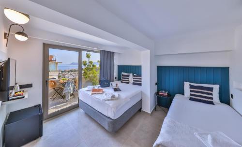 卡斯Aphrodite Hotel Kaş的酒店客房设有两张床和一个阳台。