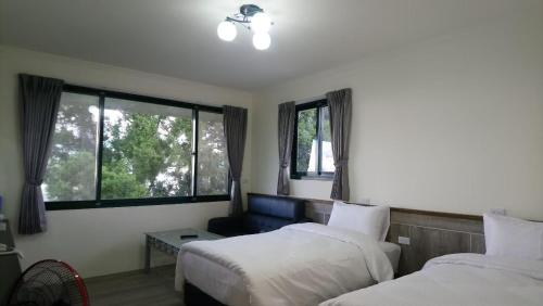 仁爱乡清境宿霧山宛的酒店客房设有两张床和窗户。