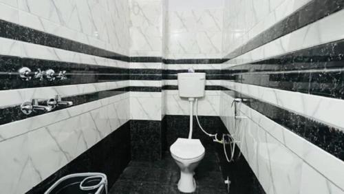 AyodhyaGoroomgo The Ram Krishna Palace Ayodhya - Luxury Room的黑白浴室设有卫生间